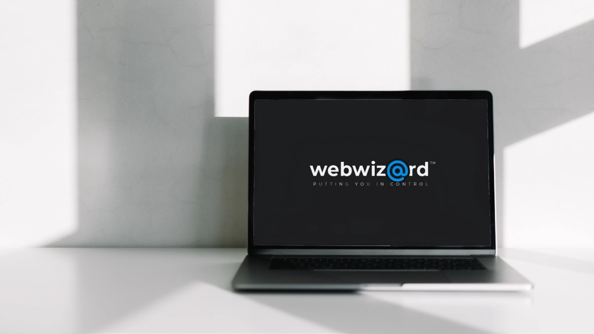 Laptop screen with Webwiz@rd logo, custom CMS.
